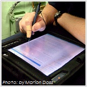 man looking at e-signature pad