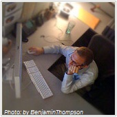 man using computer on L-shaped table
