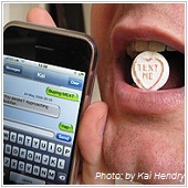 man holding cell phone with candy in lips
