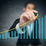 Investor with growth chart of profits.