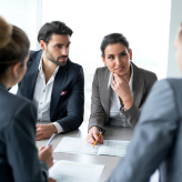 Smiling group of successful business people on a meeting